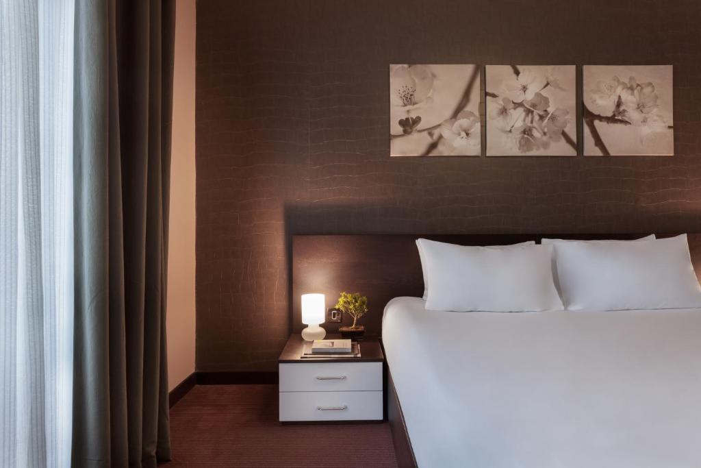 Postel nebo postele na pokoji v ubytování Hotel Argento
