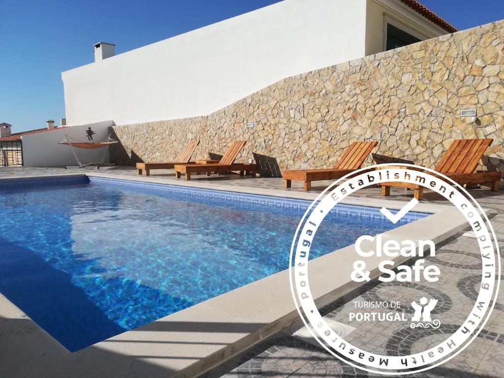 a clock sitting next to a swimming pool at Rex Surf House in Areia Branca