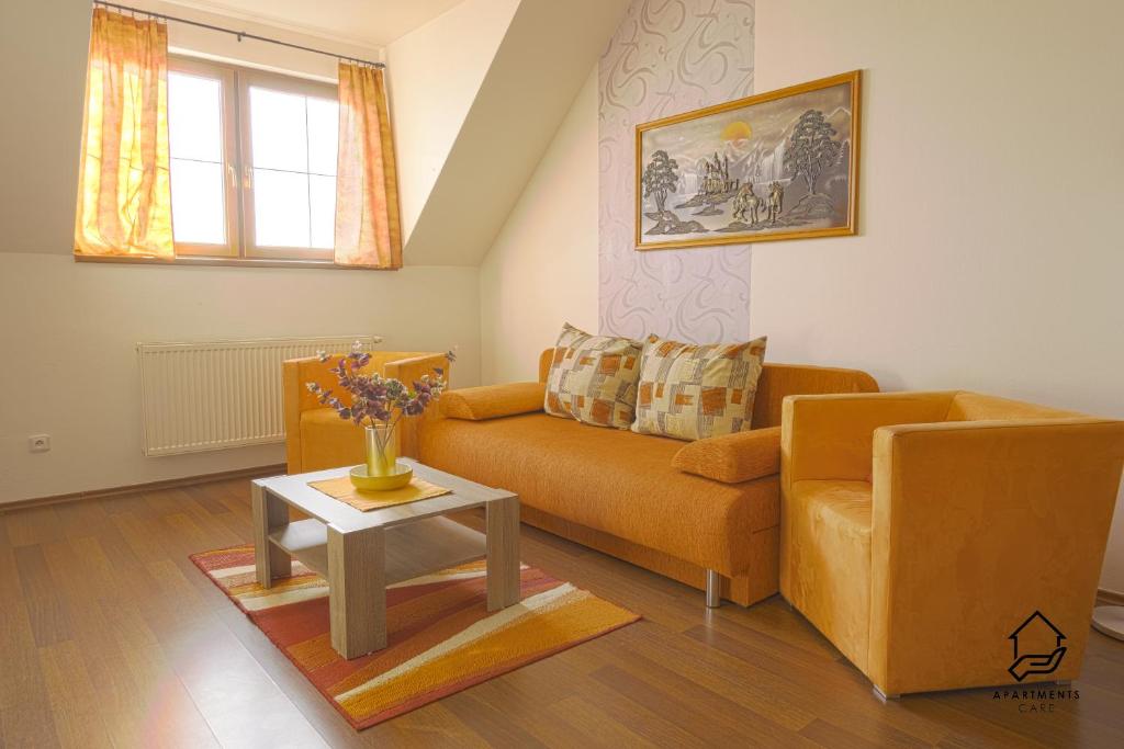 a living room with a couch and a table at TATRYSTAY Apartment C3 in Veľká Lomnica