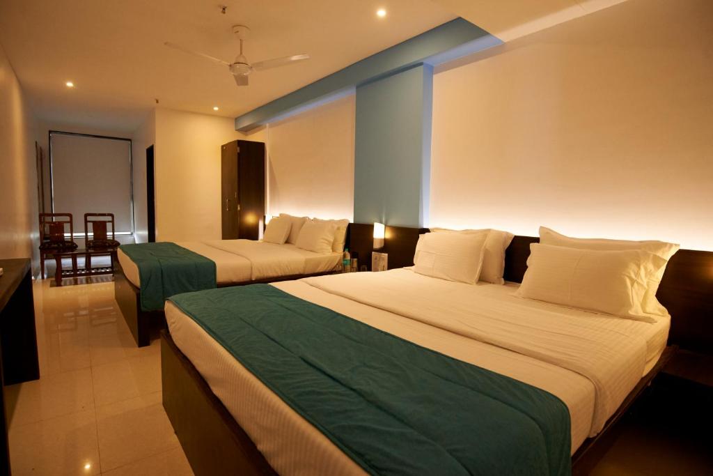 Postel nebo postele na pokoji v ubytování HOTEL CITY POINT