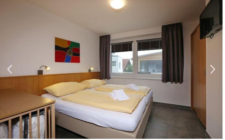 A bed or beds in a room at Deluxe Apartment SCHRABERGER TOP 6