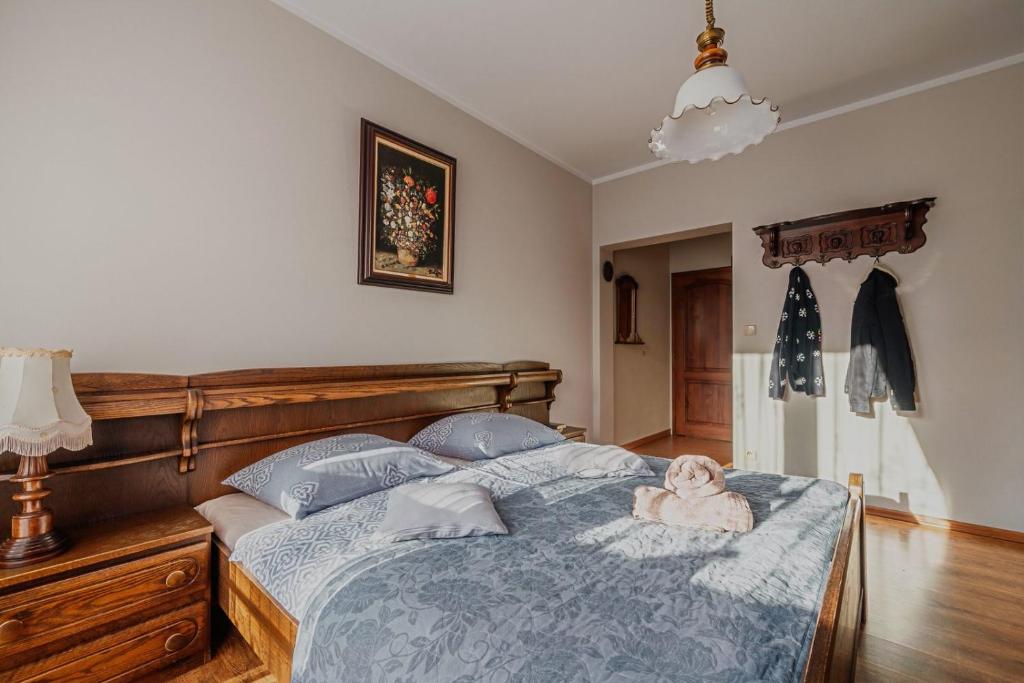 a bedroom with a bed with a stuffed animal on it at Villa Nawrot in Zakopane