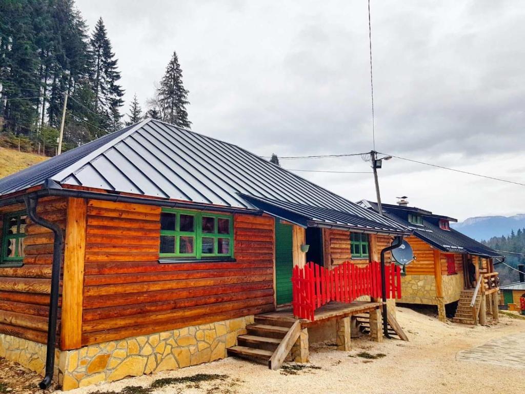 a small wooden house with a black roof at Apartman Trebević Dolina mira in Pale