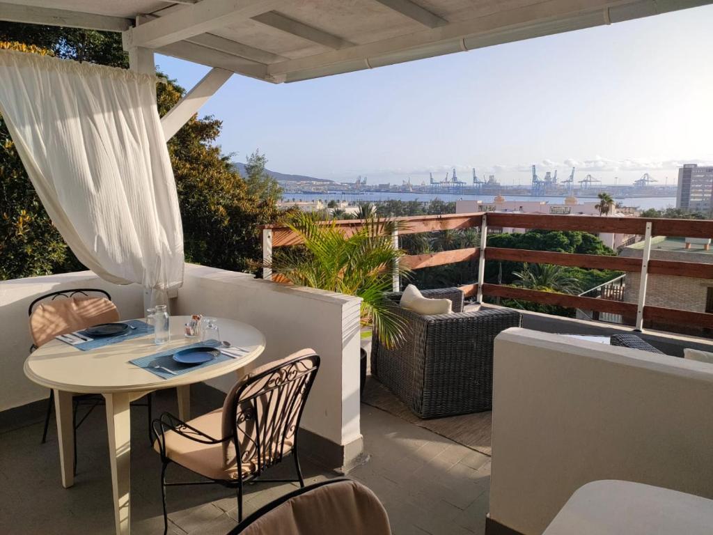 patio con mesa y sillas en el balcón en Casa Doramas B&B VV, en Las Palmas de Gran Canaria