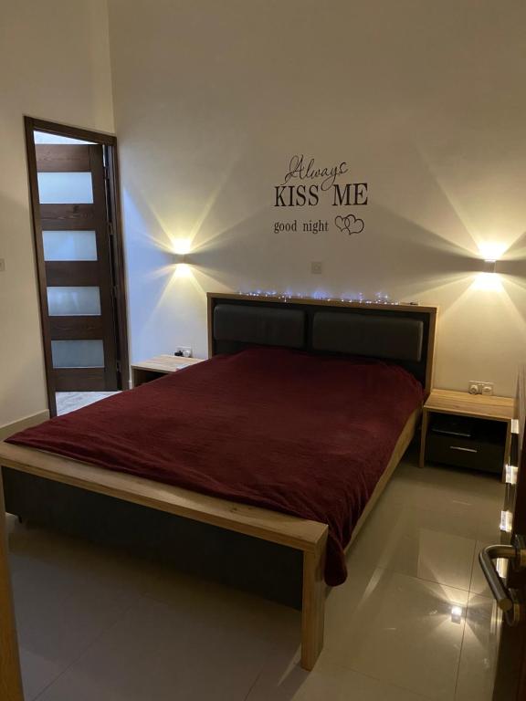 Schlafzimmer mit einem Bett mit einer roten Bettdecke in der Unterkunft St Orsola Apartment 2 in Victoria