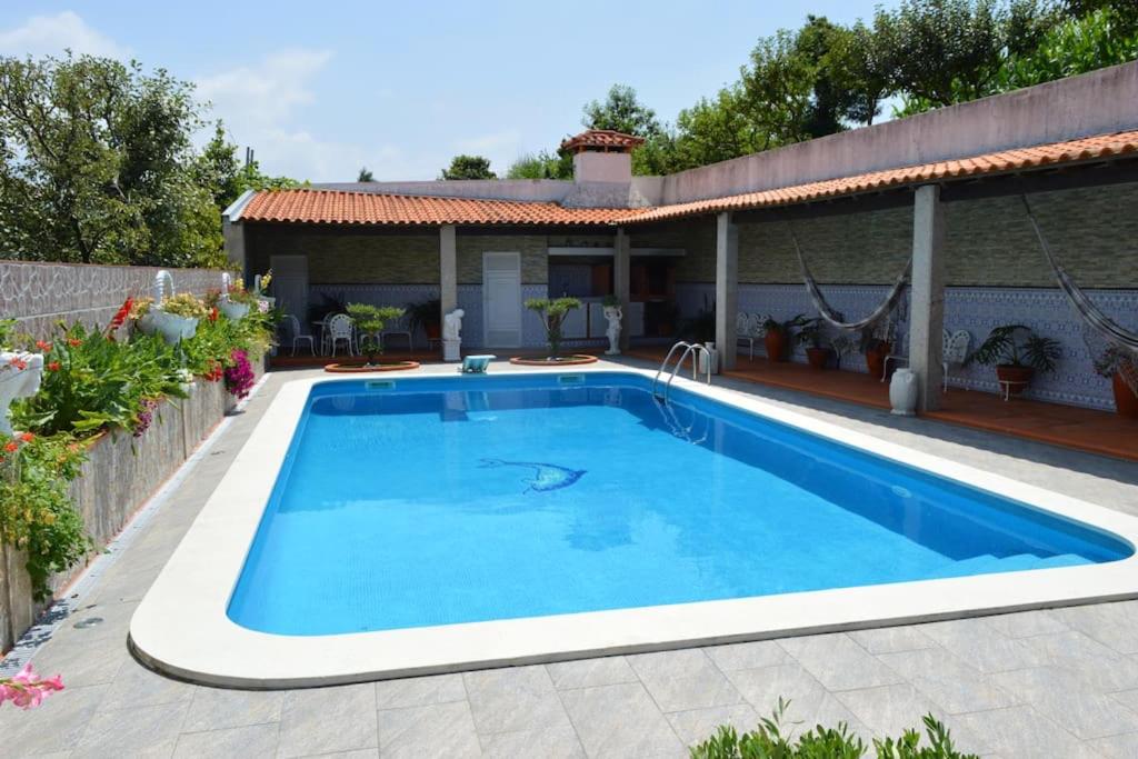 a swimming pool in front of a house at Spacious Villa with Private Pool in Oliveira de Azeméis in Oliveira de Azemeis