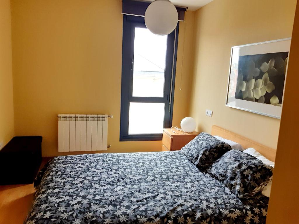 a bedroom with a bed and a window at 2 bedrooms apartement with terrace at Puerto de Vega 3 km away from the beach in Puerto de Vega