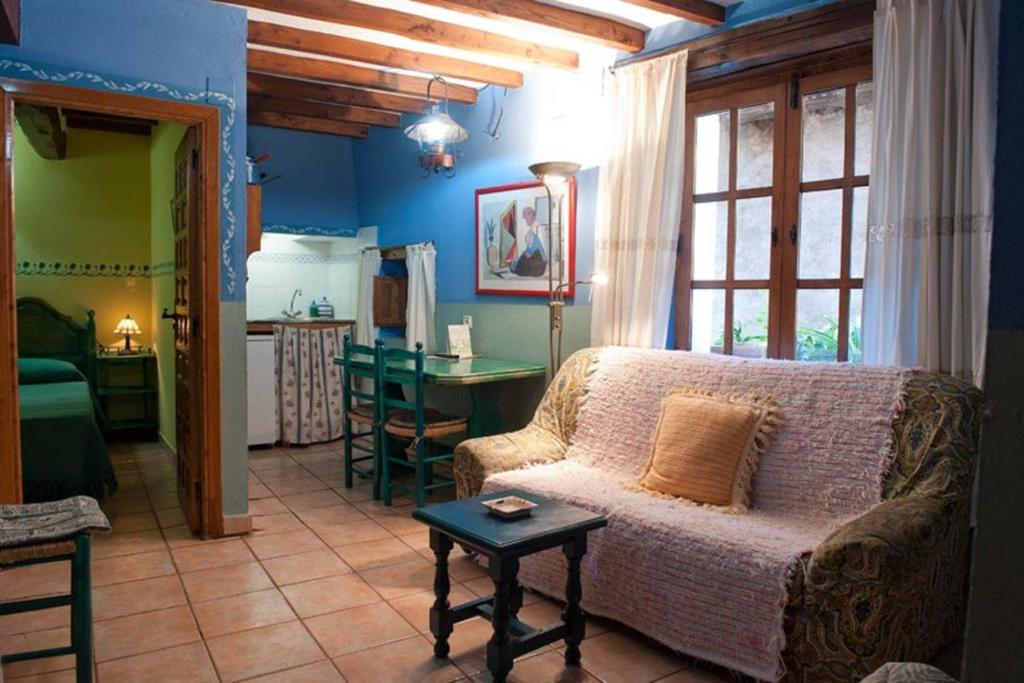 a living room with a couch and a kitchen at Cosy Apartment in Robledillo de Gata - 45 sqm - Fireplace in Robledillo de Gata