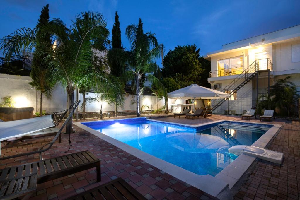 a swimming pool in front of a house at Villa 56 Luxury apartments in Rhodes Town