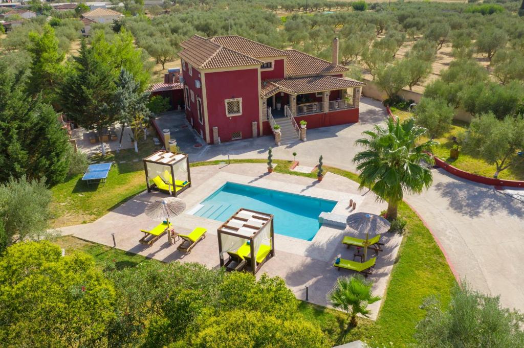 an aerial view of a house with a swimming pool at Luxury Villa Froso in Ambelókipoi