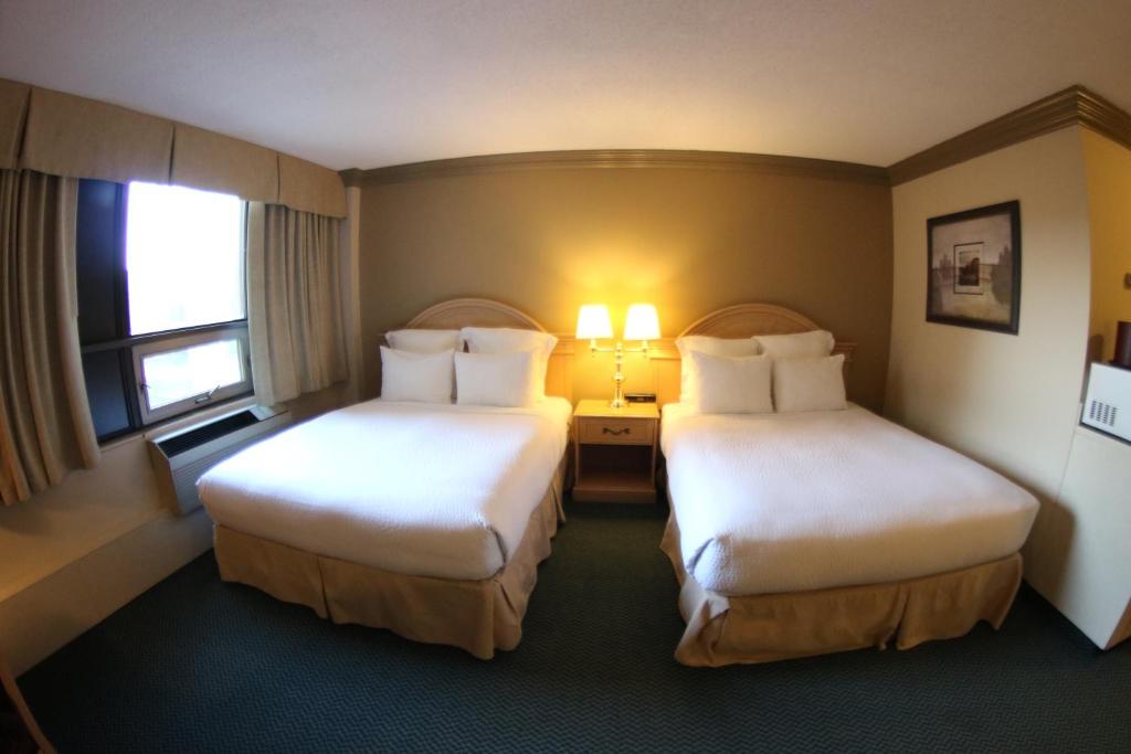 Postel nebo postele na pokoji v ubytování Nomad Hotel & Suites