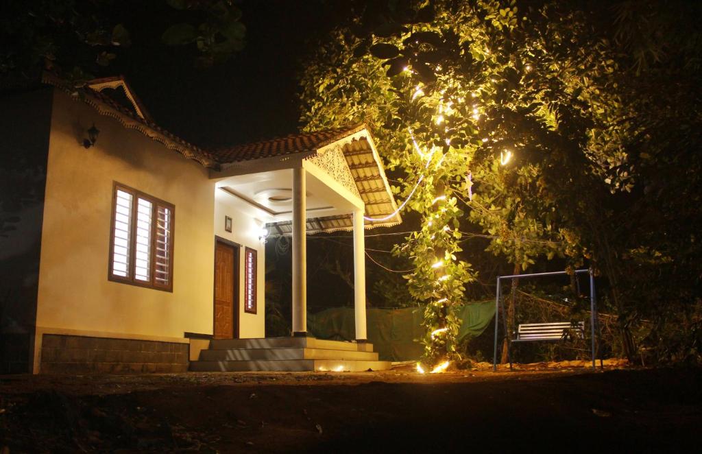 a house with christmas lights in front of it at Wayanad Days in Mananthavady
