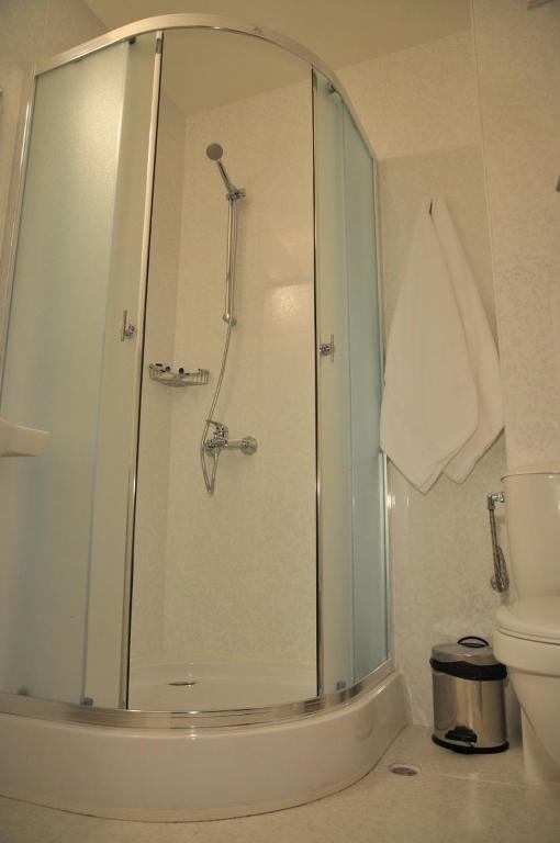 a bathroom with a shower and a toilet at Hotel Burgas Free University in Burgas