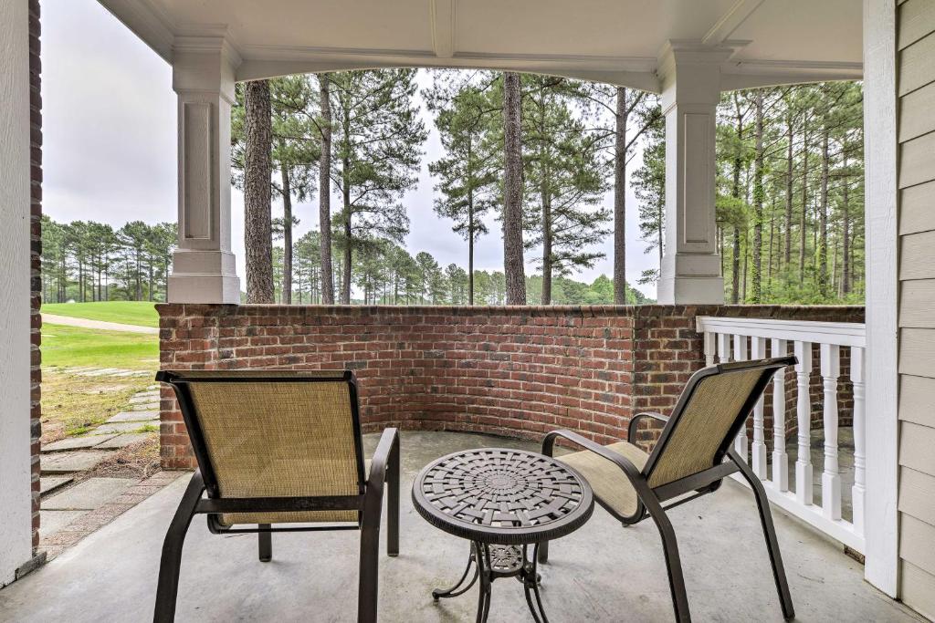 a patio with two chairs and a table on a porch at Resort-Style Condo on Golf Course with Private Pool! in Spring Lake