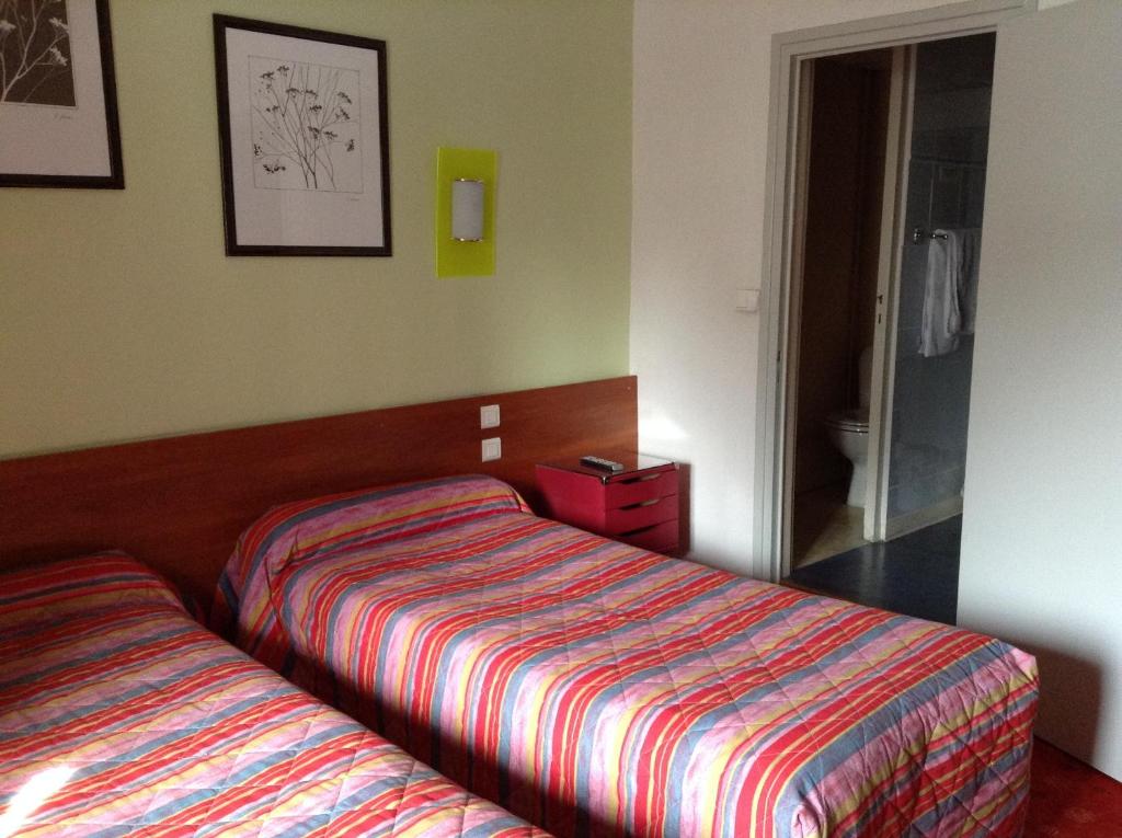 Postel nebo postele na pokoji v ubytování Hôtel Du Stade
