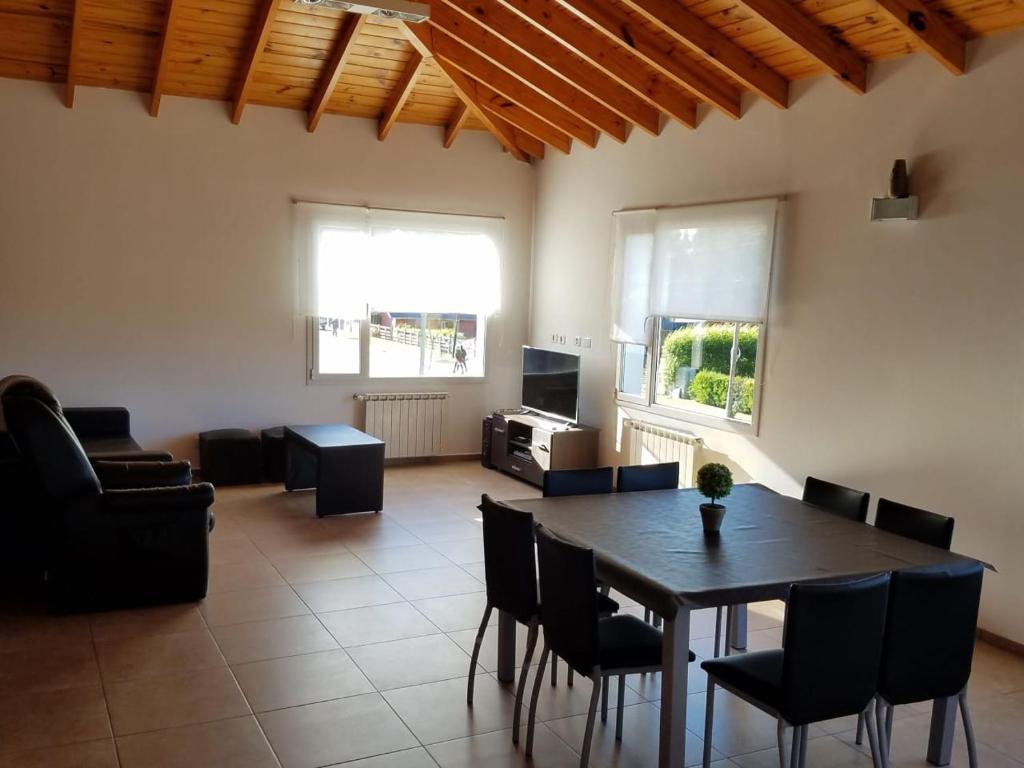 a living room with a dining room table and chairs at DEPARTAMENTO CALAFATE CENTRICO #3 in El Calafate