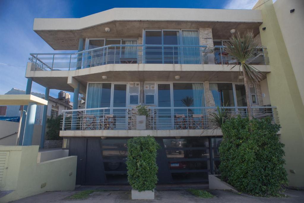 a large house with a balcony on top of it at Amares Apart - Departamentos 1 y 2 in Santa Clara del Mar