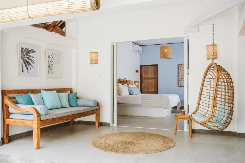 a living room with a couch and a bed at Karma Kayak in Gili Trawangan