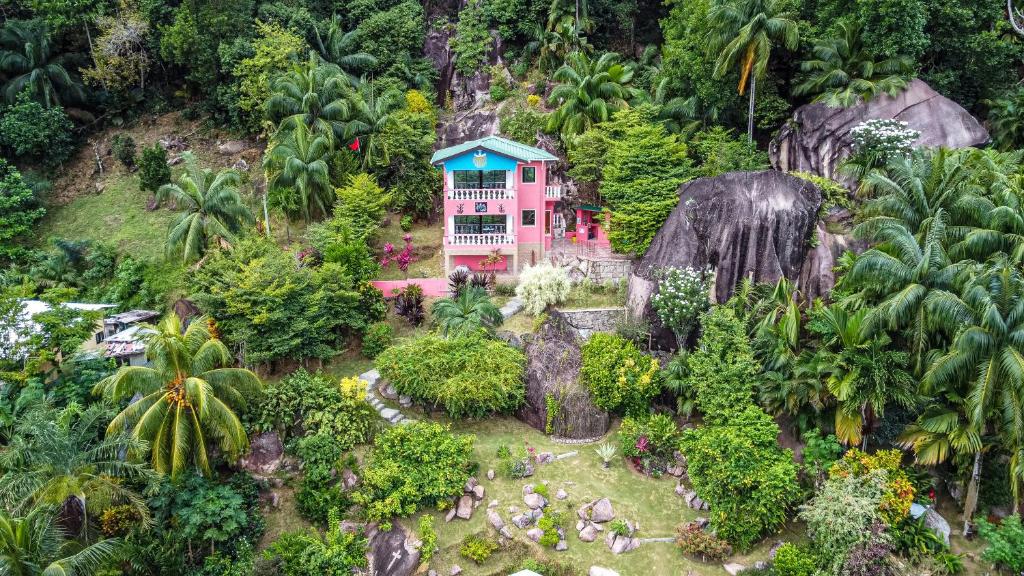 a house in the middle of a mountain at Les Elles Guesthouse Self Catering in Baie Lazare Mahé