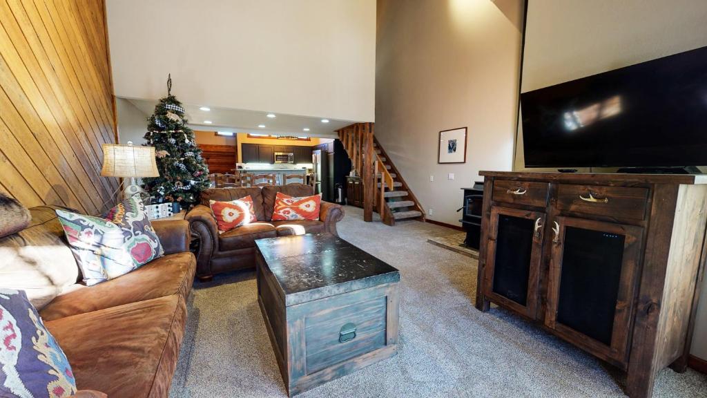 a living room with a television and a christmas tree at Snowcreek Iii #415 Condo in Mammoth Lakes