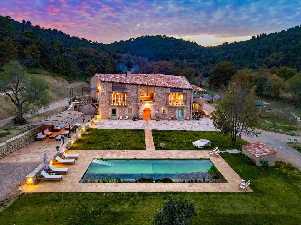 an aerial view of a house with a swimming pool at ECOTurisme Can Buch HOTEL in Sant Aniol de Finestras