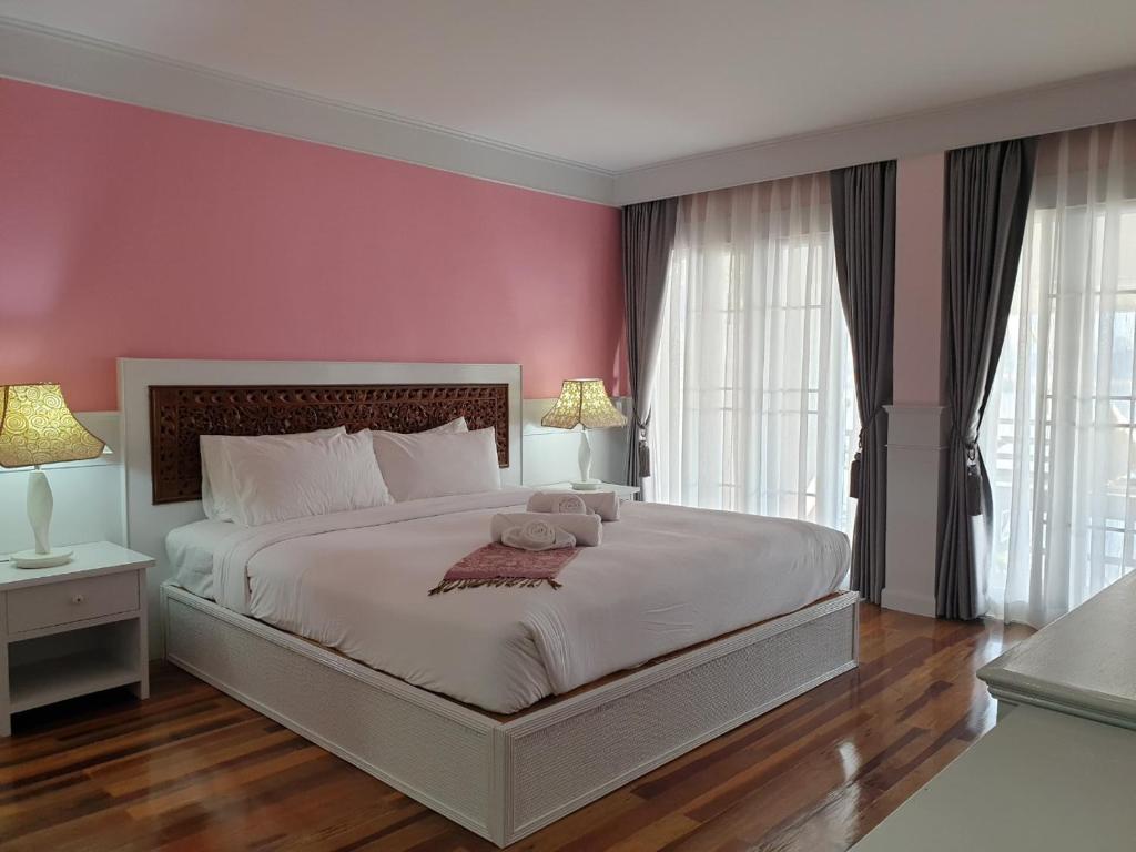 Postel nebo postele na pokoji v ubytování ริเวอร์บรีซ เชียงแสน River Breeze Chiangsean