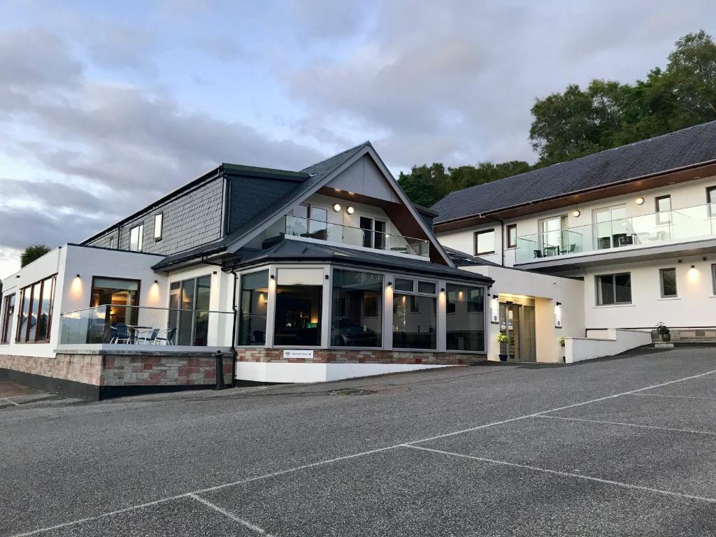 a building with a parking lot in front of it at Clan Macduff Hotel in Fort William