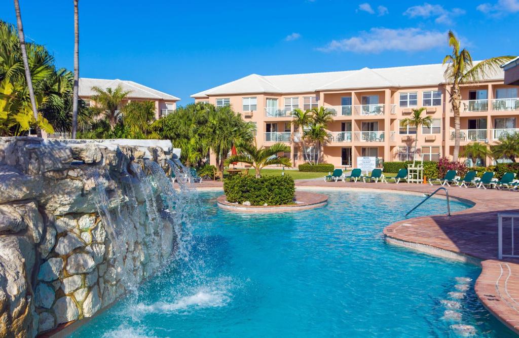 a pool at a resort with a waterfall at Island Seas Resort in Freeport