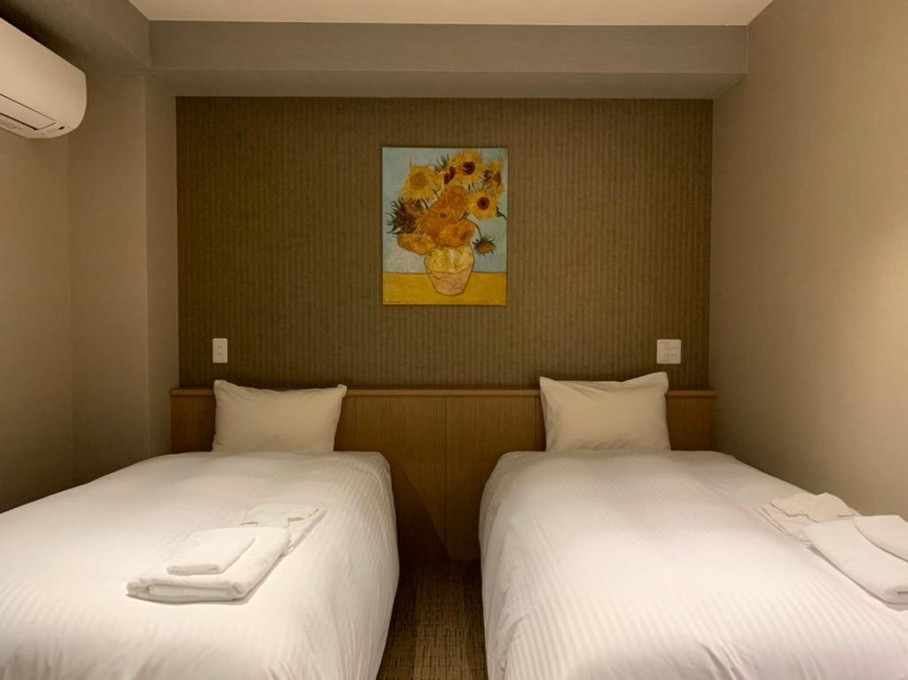 Postel nebo postele na pokoji v ubytování ikoi HOTEL