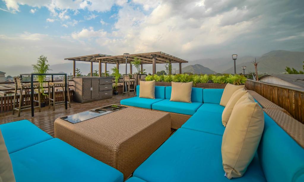 a blue couch sitting on a rooftop patio at The Kabo in Srinagar