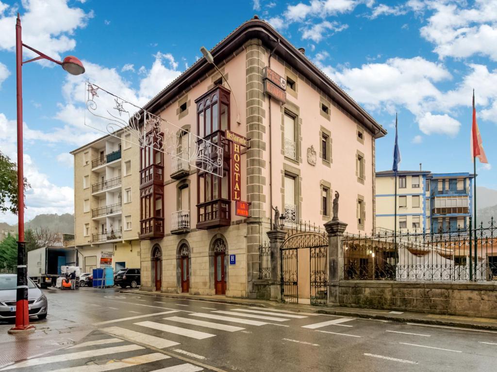 a building on the corner of a street at Hostal Restaurante La pinta in Ampuero
