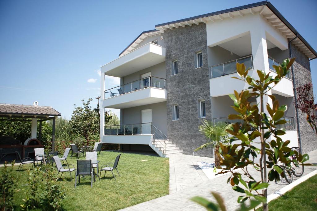 an apartment building with a yard with chairs at Casa Domenica in Stavros
