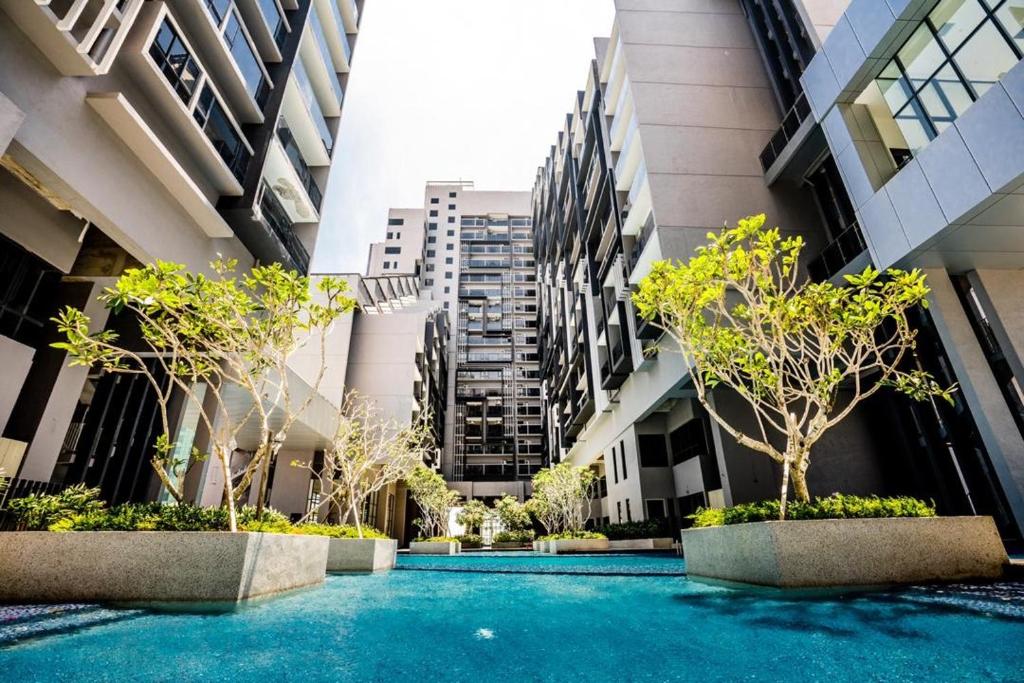 a courtyard in a building with trees and buildings at IMPERIO BY MICASA in Melaka