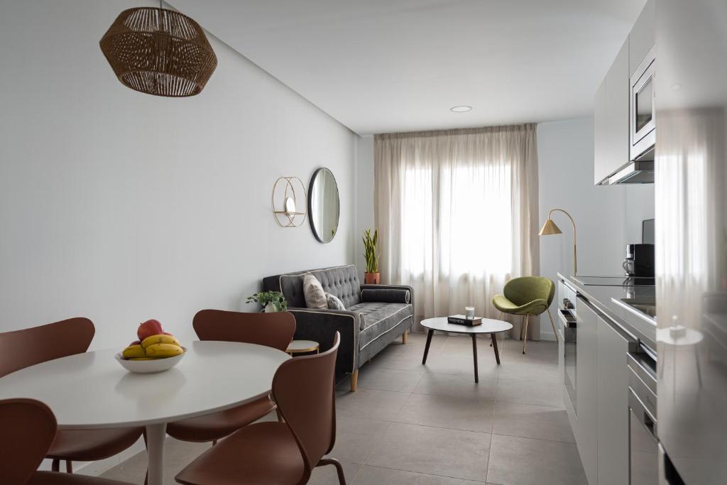a living room with a table and a couch at Royal Flats in Las Palmas de Gran Canaria