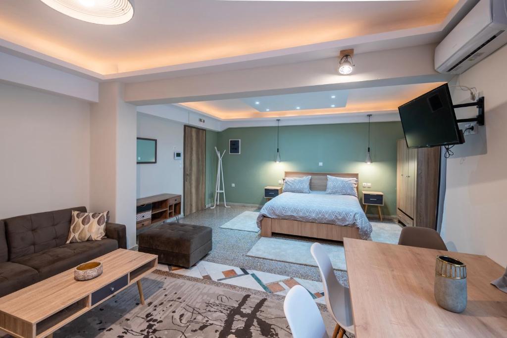 a living room with a bedroom and a bed and a table at Ririka Athens Homes - Cosy Apartments in Monastiraki, Athens Historical Centre in Athens
