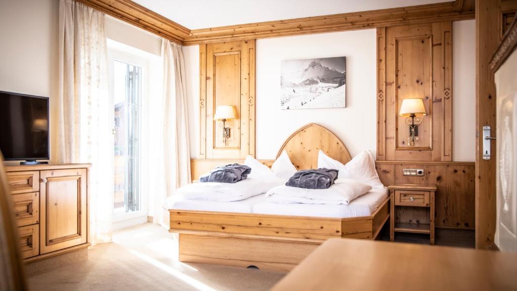 Кровать или кровати в номере Anthony´s Alpin Hotel Garni