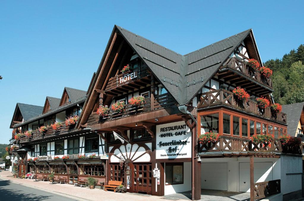 a building with flower boxes on the front of it at Hotel Sauerländer Hof in Willingen