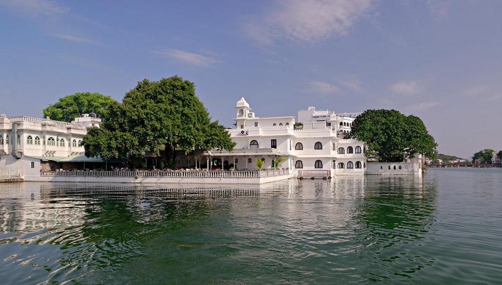 a large white building in the middle of the water at Amet Haveli in Udaipur