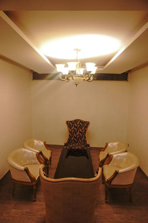 a dining room with chairs and a table and a chandelier at Ramada Plaza By Wyndham, Chandigarh Zirakpur in Chandīgarh