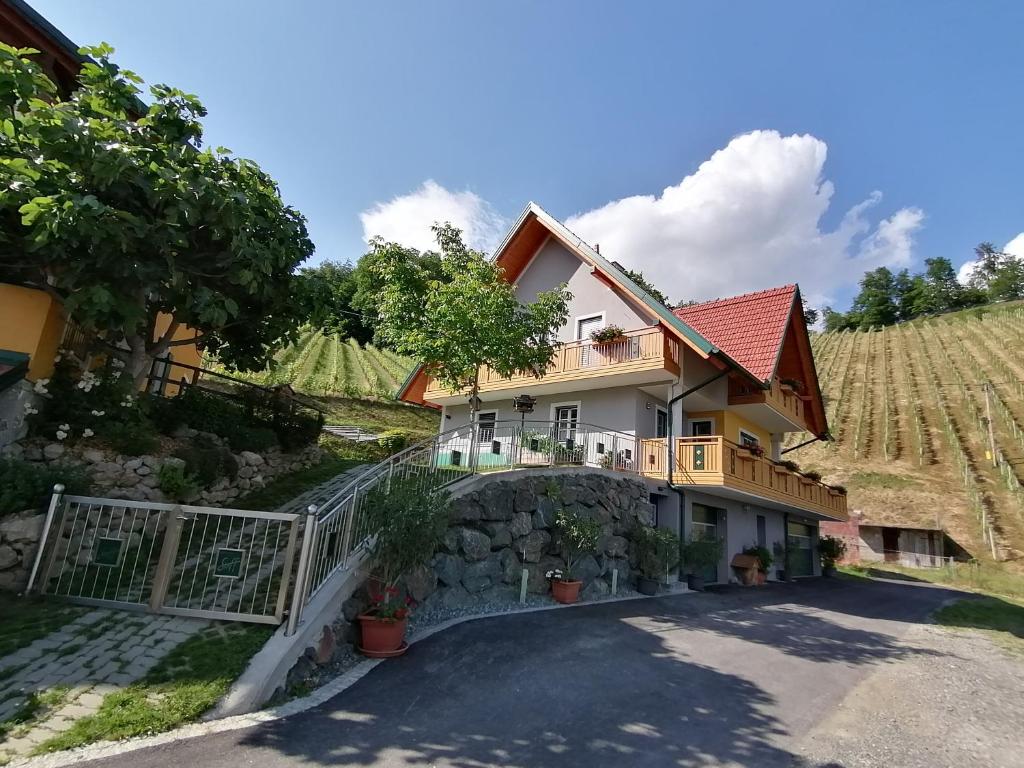 a house in a vineyard with a gate at Ferienwohnung Stoff in Kitzeck im Sausal