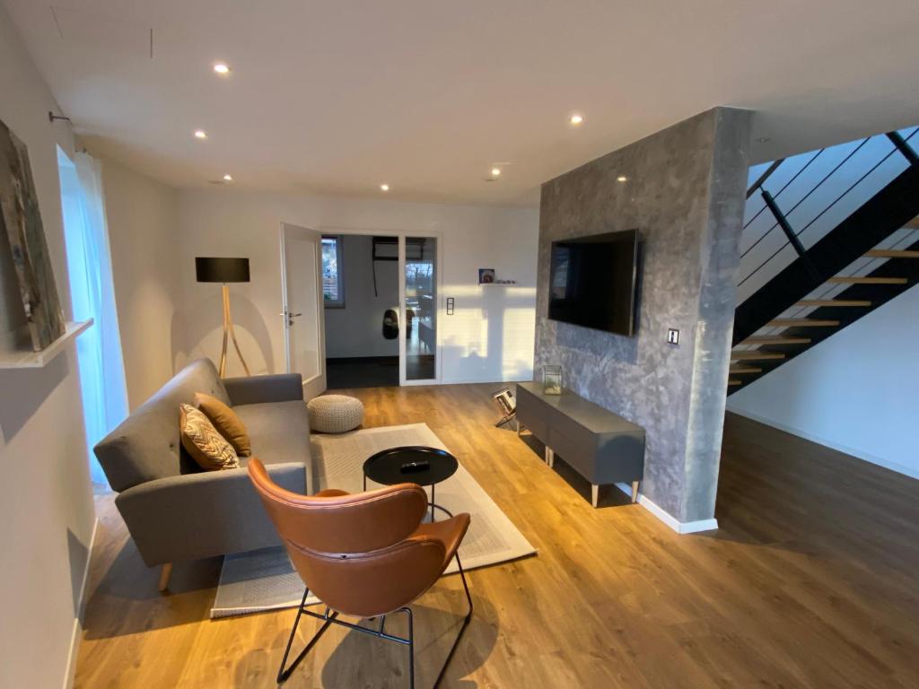 a living room with a couch and a table at Modernes Ferienhaus im Schwarzwald in Freiamt