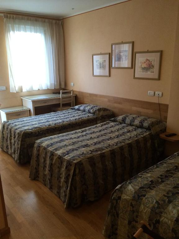 Postel nebo postele na pokoji v ubytování Hotel Concordia