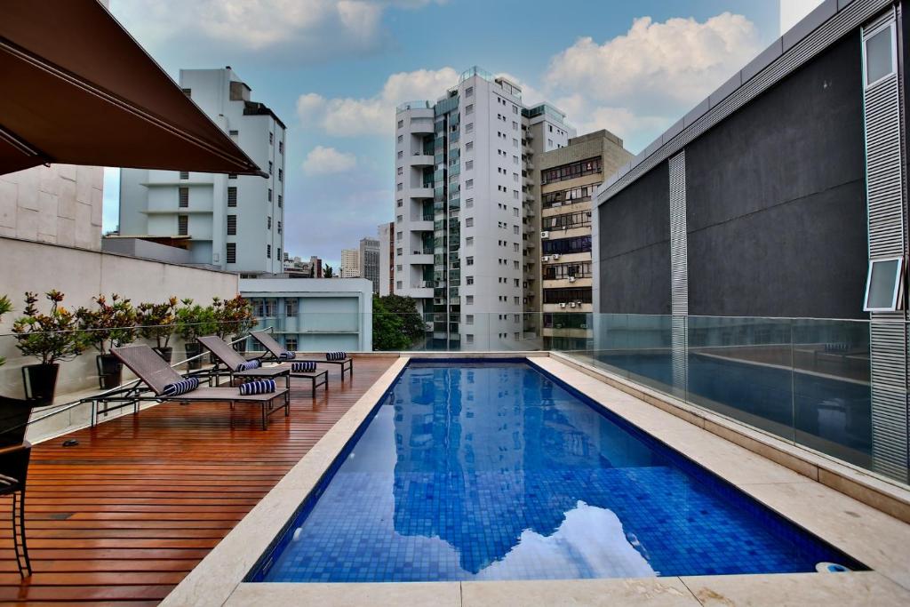 a large swimming pool in front of a large building at Ramada by Wyndham Belo Horizonte Lourdes in Belo Horizonte