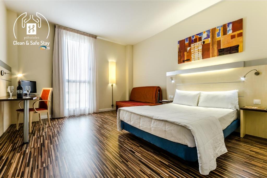 a hotel room with a bed and a desk at Hotel YIT Ciudad De Zaragoza in Zaragoza