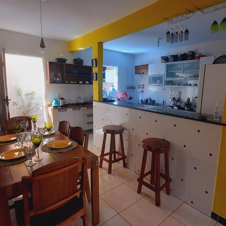 a kitchen with a table and chairs and a dining room at Canto da Lua in Lençóis