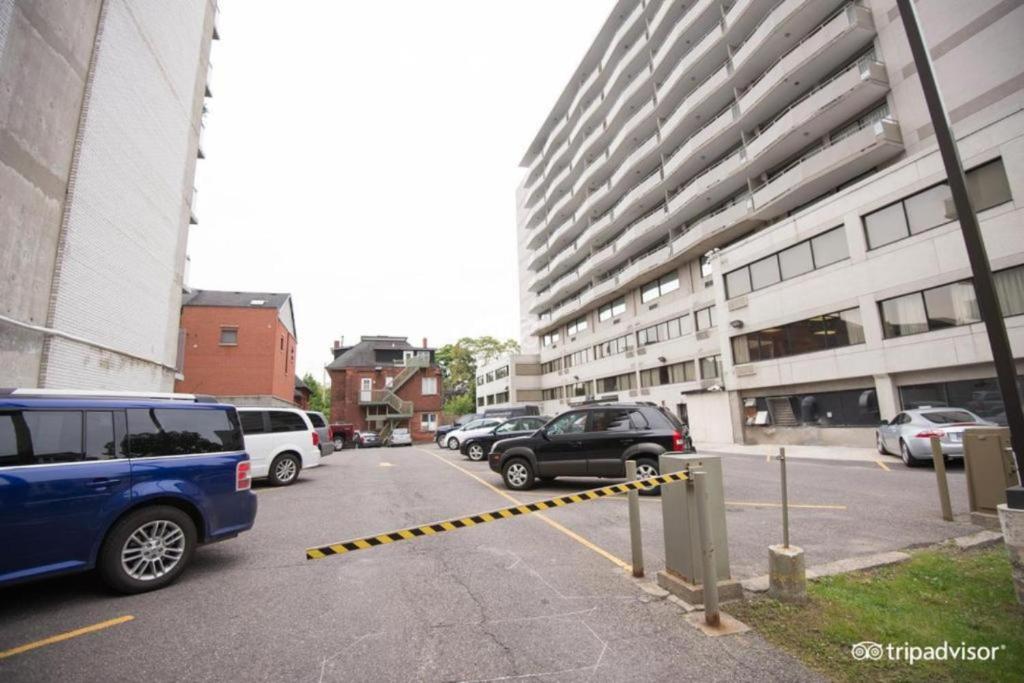a parking lot with cars parked next to a building at The Business Inn in Ottawa