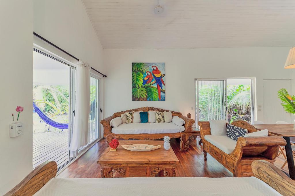 a living room with a couch and a table at Pineapple house Manzanillo in Manzanillo