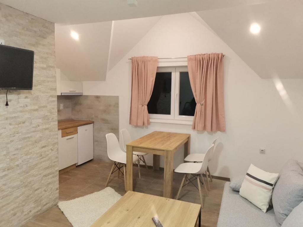 a kitchen and living room with a table and chairs at Vila Vrh in Crni Vrh