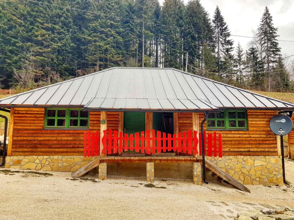 a small wooden house with a tin roof at Apartman Zelengora Dolina mira in Pale