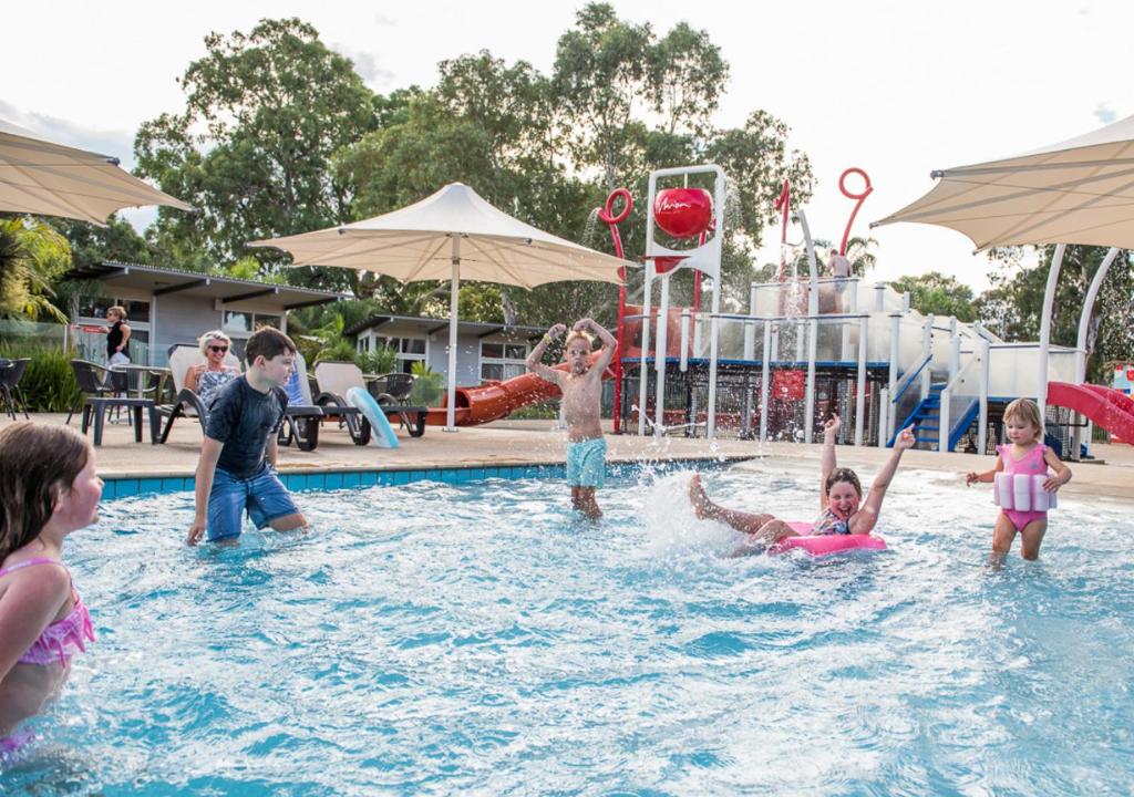 a group of children playing in a swimming pool at Marion Holiday Park in Adelaide